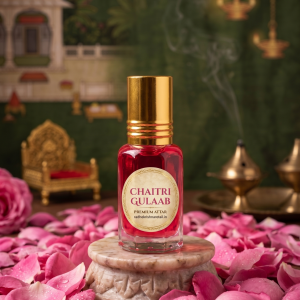 Chaitri Gulab attar bottle for Thakorji seva placed on a marble stand with flower petals in a devotional setting