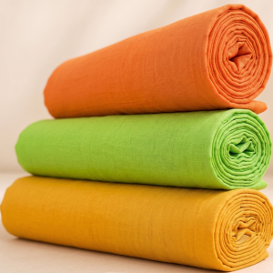 Three rolled plain kapad pieces stacked as a Pushtimarg trio for Thakorji seva and devotional vastra use