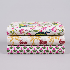 Three folded printed vastra pieces with lotus, peacock and palm motifs in a Pushtimarg devotional combo set.
