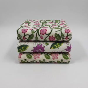 Three folded printed vastra pieces with lotus and leaf motifs, arranged as a Pushtimargiya shringar combo set.
