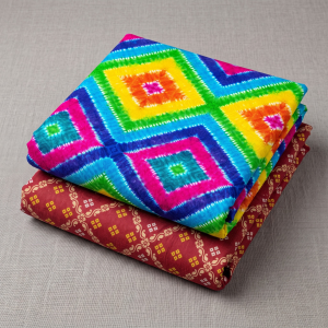 Vibrantly colored traditional Bandhani and printed Vastra for Thakorji shringar Seva at Radha Krishna Retail.