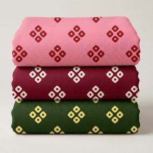 Three folded printed vastra pieces stacked as a Thakorji shringar combo set with repeating diamond motifs.