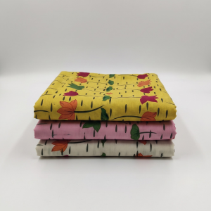 Stack of three folded printed vastra pieces for Thakorji shringar, arranged as a devotional fabric combo set.