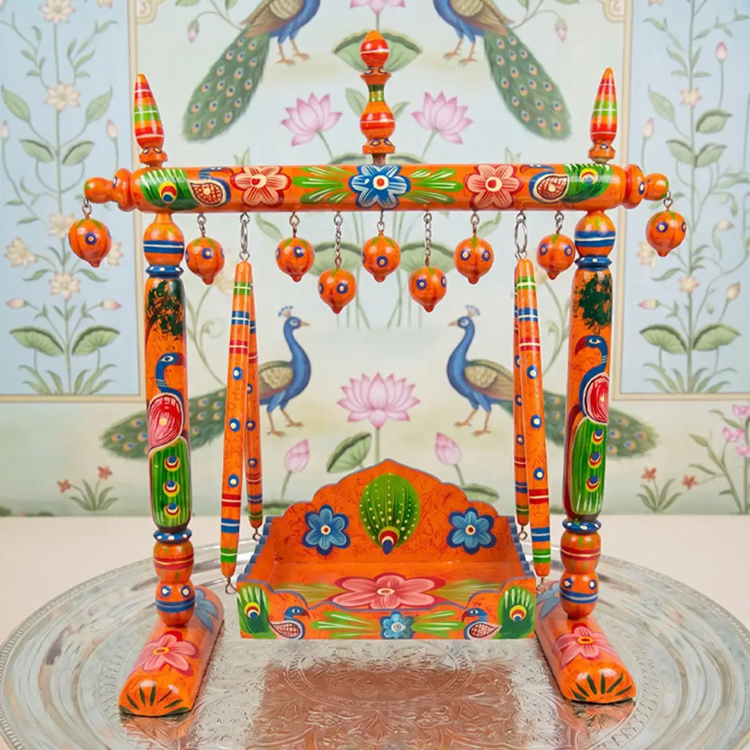 Hand-painted wooden hindola jhula with peacock design for pushtimarg seva.