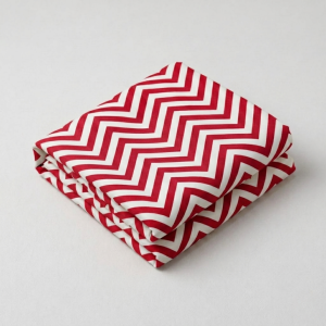 Folded red and white chevron leheriya fabric with bold zig-zag wave patterns