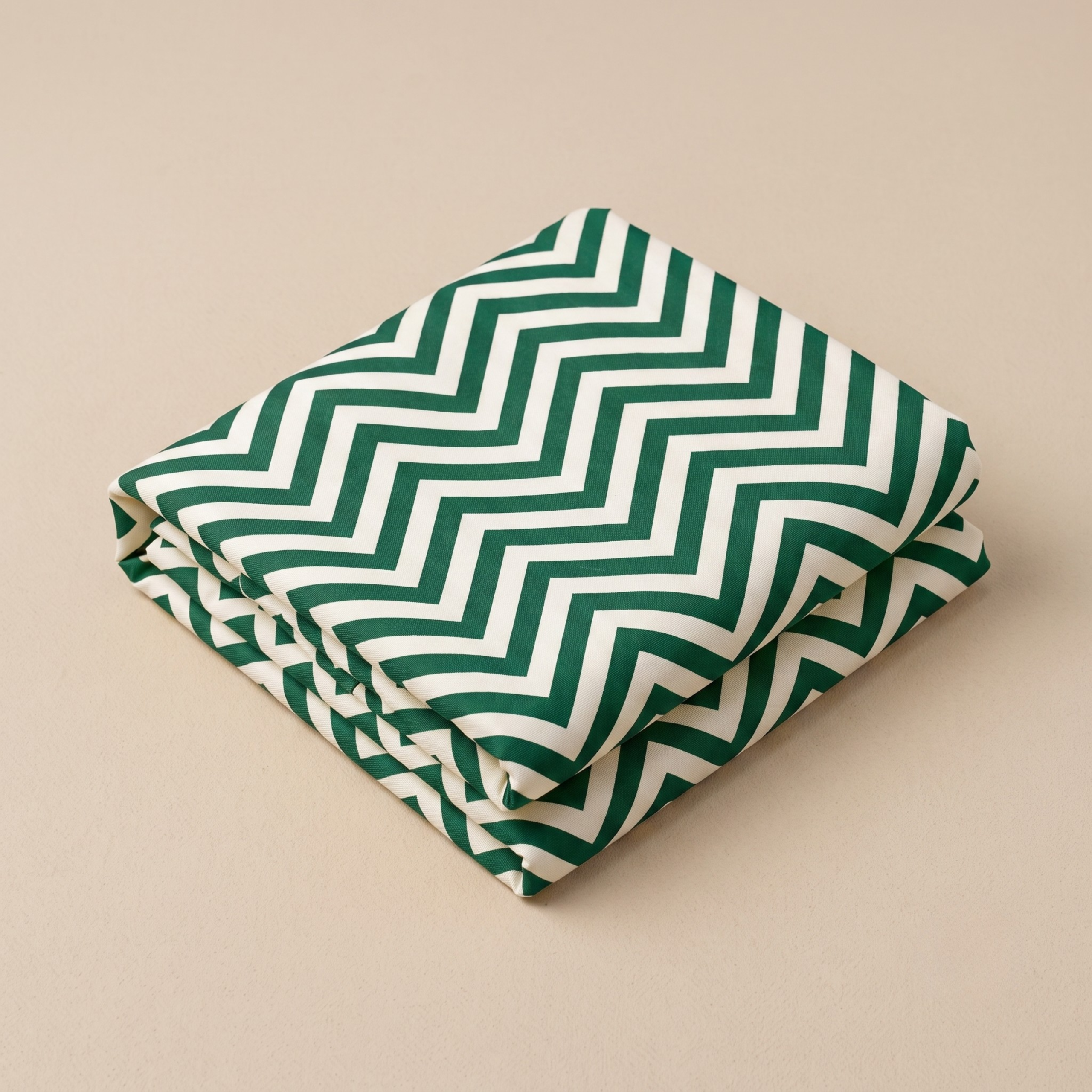 Folded green and cream chevron leheriya fabric featuring crisp zig-zag wave patterns