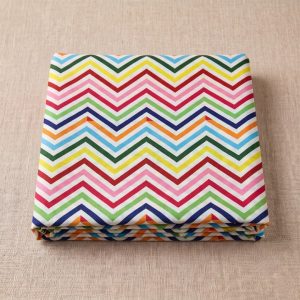 Folded multicolor chevron leheriya fabric with bold zig-zag wave patterns