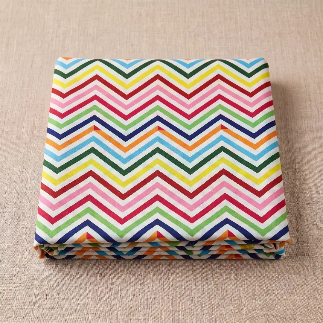 Folded multicolor chevron leheriya fabric with bold zig-zag wave patterns