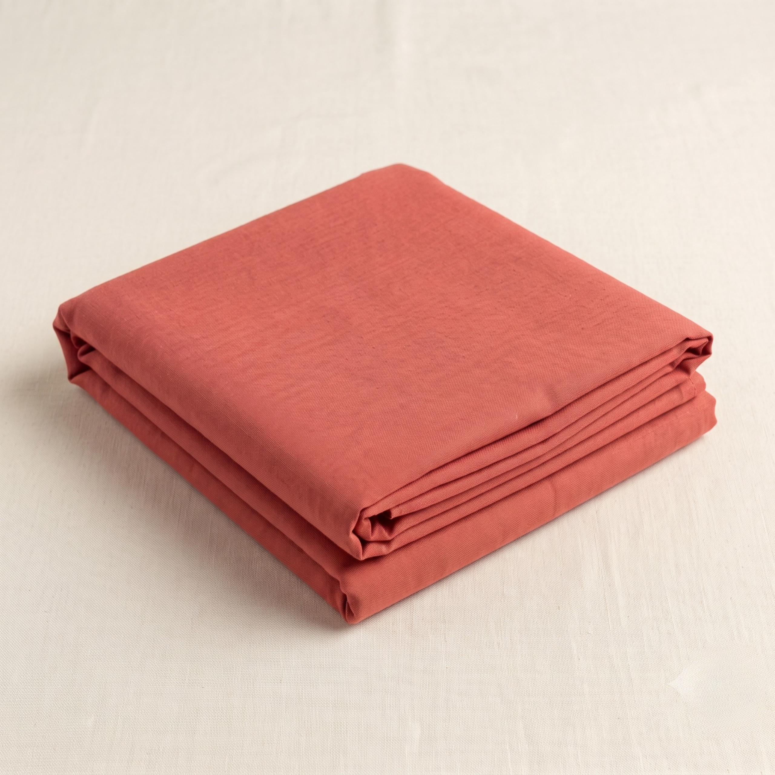 Neatly folded peach malmal kapda for ushnakal seva.