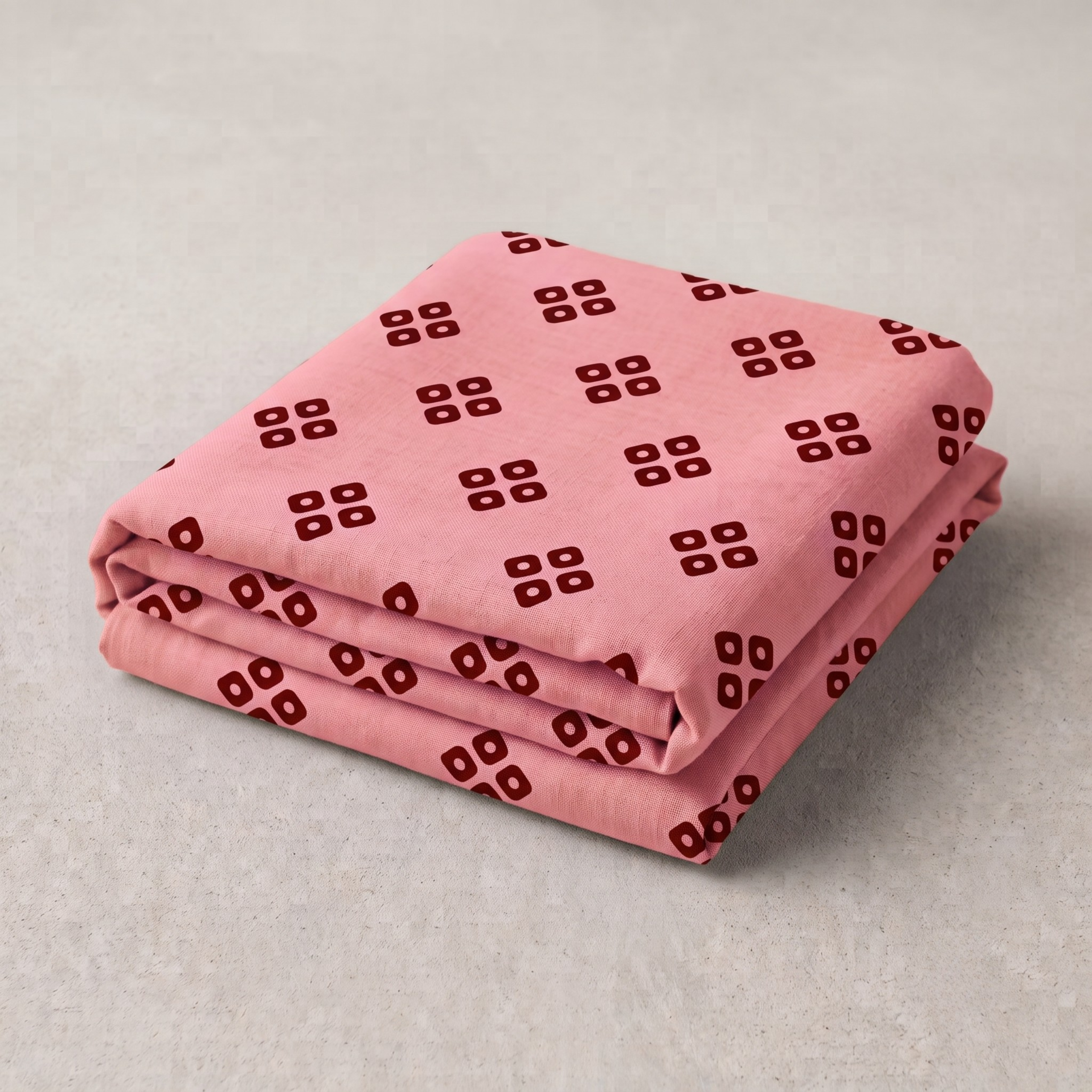 Neatly folded soft pink bandhani vastra for pushtimarg seva featuring red geometric prints.