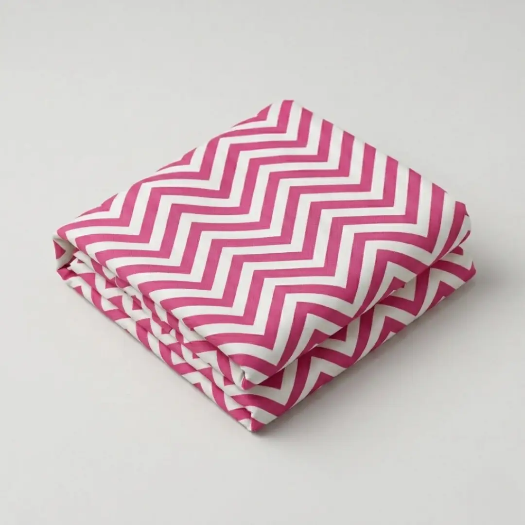 Folded pink and white chevron leheriya fabric showcasing bold zig-zag wave patterns
